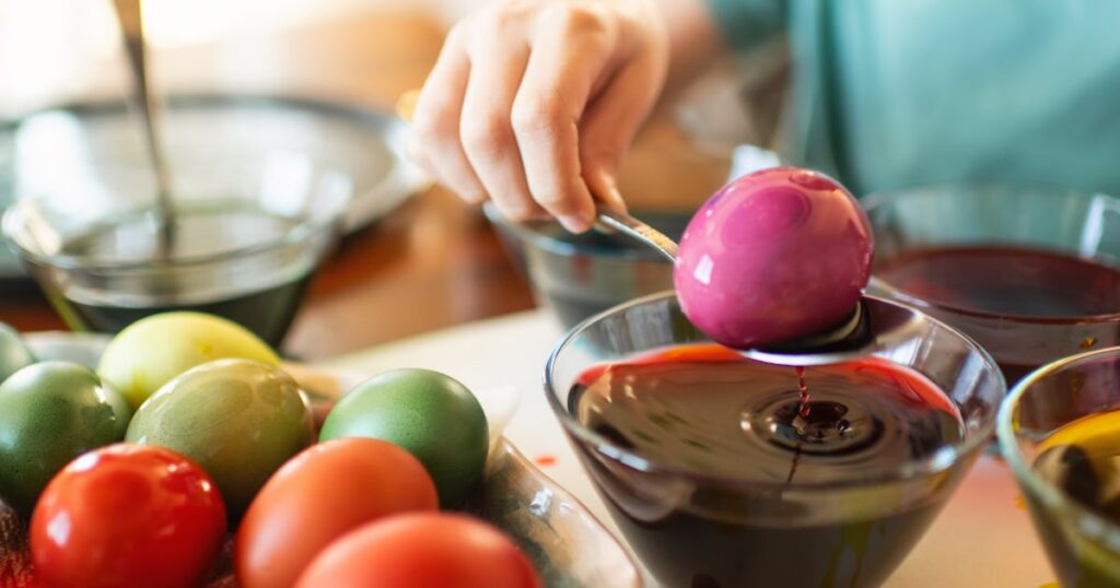 boy painting easter eggs